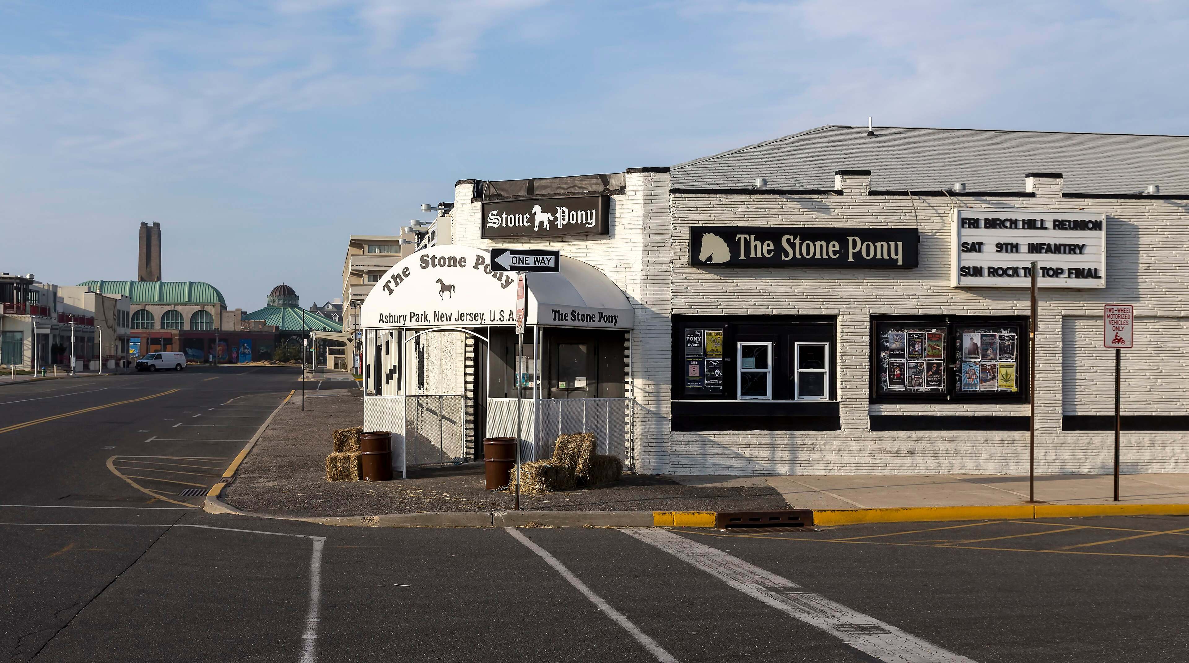 The white-painted Stone Pony music club on a quiet Asbury Park street, with its marquee and awning.